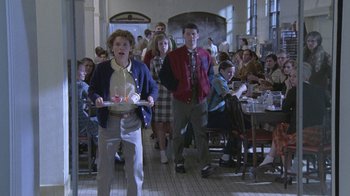 Movie still from “Temple Grandin” (2010), directed by Mick Jackson – A group of people standing in a room with tables; Wide shot, High angle