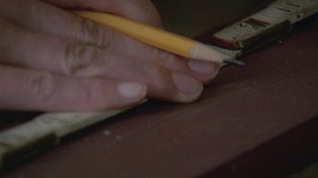 Movie still from “Temple Grandin” (2010), directed by Mick Jackson – A hand holding a pencil and a ruler; Extreme Close Up shot, High angle