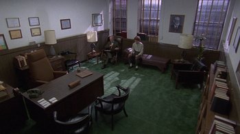 Movie still from “Temple Grandin” (2010), directed by Mick Jackson – Two people sitting on a couch in a room; Extreme Wide shot, High angle