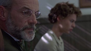Movie still from “Temple Grandin” (2010), directed by Mick Jackson – An older man and a younger woman are sitting side by side; Close Up shot, Low angle
