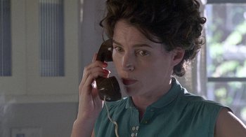 Movie still from “Temple Grandin” (2010), directed by Mick Jackson – A woman talking on a phone while wearing a blue shirt; Close Up shot, Low angle