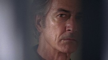 Movie still from “Temple Grandin” (2010), directed by Mick Jackson – A man's face in a dark room; Close Up shot, Over the shoulder angle