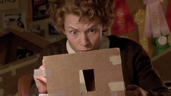 Movie still from “Temple Grandin” (2010), directed by Mick Jackson – A woman holding up a piece of cardboard with a hole in it; Close Up shot, Overhead angle