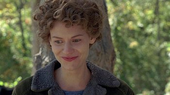 Movie still from “Temple Grandin” (2010), directed by Mick Jackson – A person with curly hair smiling; Close Up shot, Over the shoulder angle