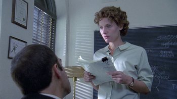 Movie still from “Temple Grandin” (2010), directed by Mick Jackson – A woman standing next to a man in a room; Close Up shot, Over the shoulder angle