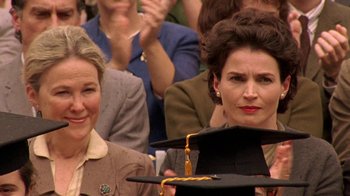 Movie still from “Temple Grandin” (2010), directed by Mick Jackson – Two women in front of an audience holding a graduation cap; Close Up shot, Over the shoulder angle