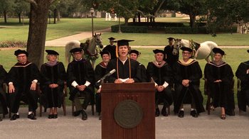 Movie still from “Temple Grandin” (2010), directed by Mick Jackson – A group of people in graduation attire sitting in front of a podium; Wide shot, High angle