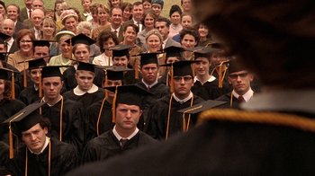Movie still from “Temple Grandin” (2010), directed by Mick Jackson – A large group of people wearing graduation caps and gowns; Medium shot, Over the shoulder angle