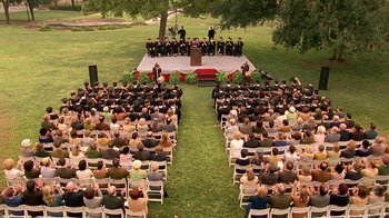 Movie still from “Temple Grandin” (2010), directed by Mick Jackson – An audience is sitting in the grass for a graduation ceremony; Extreme Wide shot, High angle
