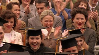 Movie still from “Temple Grandin” (2010), directed by Mick Jackson – A group of people wearing graduation caps and holding hands; Close Up shot, Over the shoulder angle