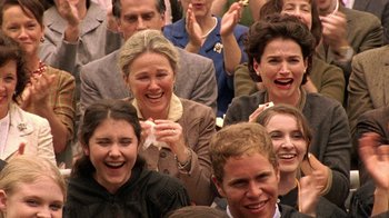 Movie still from “Temple Grandin” (2010), directed by Mick Jackson – A group of people sitting and standing in a crowd; Medium shot, Low angle