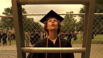 Movie still from “Temple Grandin” (2010), directed by Mick Jackson – A woman in a graduation cap and gown looking up at a crowd; Close Up shot, Low angle