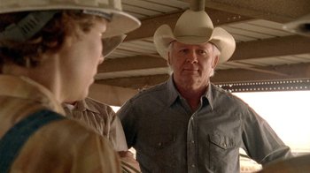 Movie still from “Temple Grandin” (2010), directed by Mick Jackson – A man wearing a cowboy hat talking to another man; Close Up shot, Over the shoulder angle