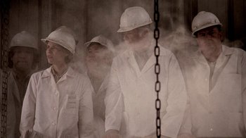 Movie still from “Temple Grandin” (2010), directed by Mick Jackson – A group of men in hard hats standing next to each other; Medium shot, Low angle