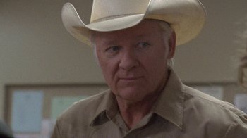 Movie still from “Temple Grandin” (2010), directed by Mick Jackson – An older man wearing a white cowboy hat; Close Up shot, Over the shoulder angle