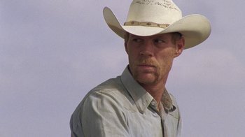 Movie still from “Temple Grandin” (2010), directed by Mick Jackson – A man wearing a cowboy hat is looking at the camera; Close Up shot, Low angle