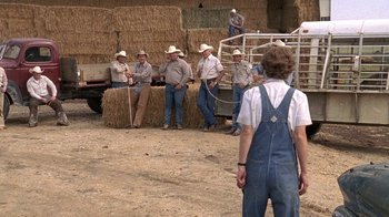 Movie still from “Temple Grandin” (2010), directed by Mick Jackson – A group of men sitting in front of a truck; Wide shot, Over the shoulder angle