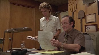 Movie still from “Temple Grandin” (2010), directed by Mick Jackson – A man and a young boy are looking at papers together; Medium shot, Over the shoulder angle