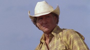 Movie still from “Temple Grandin” (2010), directed by Mick Jackson – A man wearing a cowboy hat and a plaid shirt; Close Up shot, Low angle