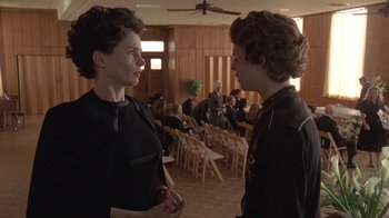 Movie still from “Temple Grandin” (2010), directed by Mick Jackson – Two women are talking in a room full of people; Medium shot, Over the shoulder angle