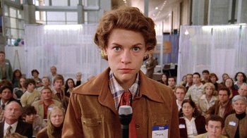 Movie still from “Temple Grandin” (2010), directed by Mick Jackson – A person with a microphone in front of a group of people; Close Up shot, Low angle