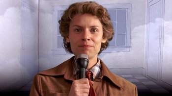 Movie still from “Temple Grandin” (2010), directed by Mick Jackson – A woman holding a microphone up to her face; Close Up shot, Low angle