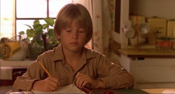 Movie still from “Tender Mercies” (1983), directed by Bruce Beresford – A young boy is sitting at a table writing with a pencil; Close Up shot, Low angle