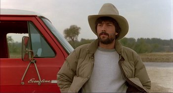 Movie still from “Tender Mercies” (1983), directed by Bruce Beresford – A man wearing a cowboy hat standing in front of a red truck; Close Up shot, Low angle