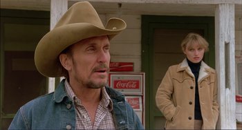 Movie still from “Tender Mercies” (1983), directed by Bruce Beresford – A man wearing a cowboy hat in front of a woman; Medium shot, Low angle
