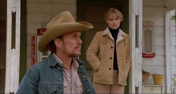 Movie still from “Tender Mercies” (1983), directed by Bruce Beresford – A man and a woman standing next to each other; Medium shot, Low angle