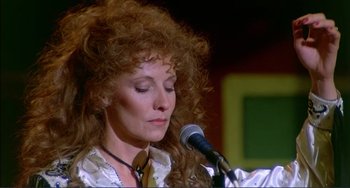 Movie still from “Tender Mercies” (1983), directed by Bruce Beresford – A person holding a microphone; Close Up shot, Low angle