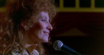 Movie still from “Tender Mercies” (1983), directed by Bruce Beresford – A person holding a microphone; Close Up shot, Low angle
