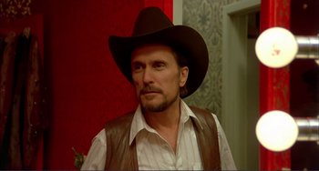 Movie still from “Tender Mercies” (1983), directed by Bruce Beresford – A man wearing a cowboy hat and a vest; Close Up shot, Over the shoulder angle