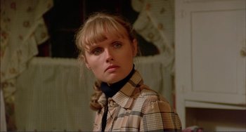 Movie still from “Tender Mercies” (1983), directed by Bruce Beresford – A woman in a checkered shirt is posing for a picture; Close Up shot, Low angle