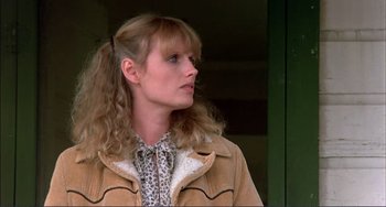 Movie still from “Tender Mercies” (1983), directed by Bruce Beresford – A woman with long blonde curly hair wearing a jacket; Close Up shot, Low angle