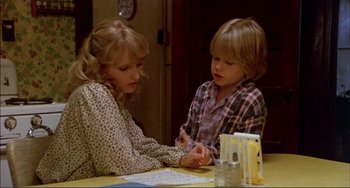 Movie still from “Tender Mercies” (1983), directed by Bruce Beresford – A woman and a boy sitting at a table; Medium shot, High angle