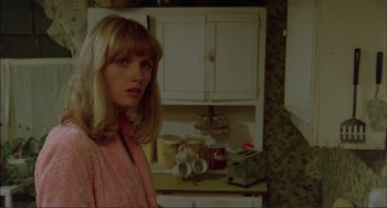 Movie still from “Tender Mercies” (1983), directed by Bruce Beresford – A woman standing in a kitchen next to a counter; Close Up shot, Low angle