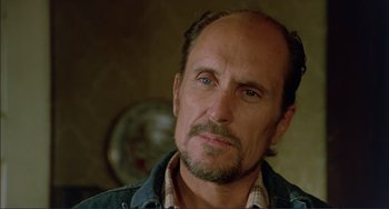 Movie still from “Tender Mercies” (1983), directed by Bruce Beresford – A person wearing a jean jacket; Close Up shot, Low angle