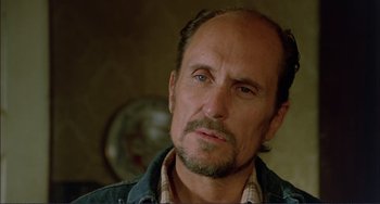 Movie still from “Tender Mercies” (1983), directed by Bruce Beresford – A person wearing a jean jacket; Close Up shot, Low angle