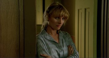 Movie still from “Tender Mercies” (1983), directed by Bruce Beresford – A woman standing in a room with her arms crossed; Close Up shot, Over the shoulder angle