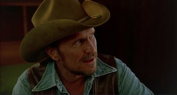 Movie still from “Tender Mercies” (1983), directed by Bruce Beresford – A person wearing a cowboy hat; Close Up shot, Low angle