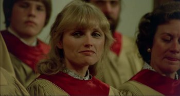 Movie still from “Tender Mercies” (1983), directed by Bruce Beresford – A person wearing a red and gold dress; Close Up shot, Low angle