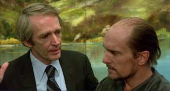 Movie still from “Tender Mercies” (1983), directed by Bruce Beresford – Two men in business suits talking to each other; Close Up shot, Over the shoulder angle