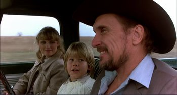 Movie still from “Tender Mercies” (1983), directed by Bruce Beresford – A man and a woman and a little girl in a car; Close Up shot, Over the shoulder angle