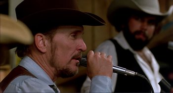 Movie still from “Tender Mercies” (1983), directed by Bruce Beresford – A man in a cowboy hat is holding a pipe; Close Up shot, Low angle