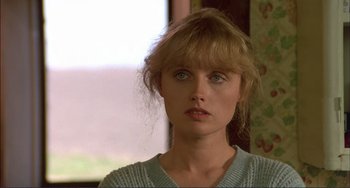 Movie still from “Tender Mercies” (1983), directed by Bruce Beresford – A person wearing a sweater and looking at the camera; Close Up shot, Over the shoulder angle