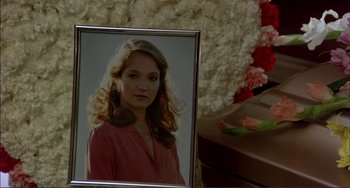 Movie still from “Tender Mercies” (1983), directed by Bruce Beresford – A picture of a young woman in front of a flower arrangement; Close Up shot, High angle
