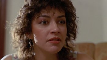 Movie still from “Tenement” (1985), directed by Roberta Findlay – A woman's face in a room; Close Up shot, Low angle