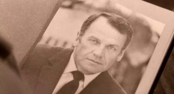 Movie still from “Teorema” (1968), directed by Pier Paolo Pasolini – An old photo of a man in a suit and tie; Extreme Close Up shot, High angle