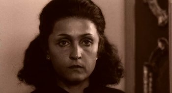 Movie still from “Teorema” (1968), directed by Pier Paolo Pasolini – An old photo of an older woman with a sad look on her face; Close Up shot, High angle